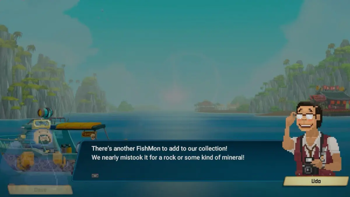 Udo dice con entusiasmo a Dave, "C'è un altro FishMon da aggiungere alla nostra collezione!  L'abbiamo quasi scambiato per una roccia o qualche tipo di minerale!" Lo sfondo è un'incantevole insenatura costiera con la barca di Dave e l'attività di sushi visibili. 
